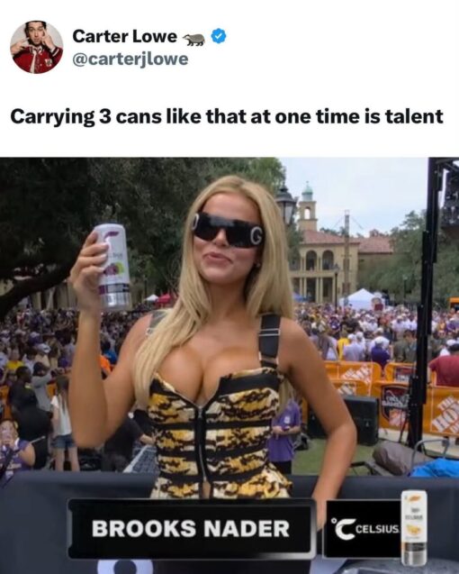 Boob Memes, Celebrity Memes, Commercial Memes, Double Meaning Memes, Football Memes, Funniest Memes, Hot Girl Memes, Innuendo Memes, Pop Culture Memes, Social Media Memes, Sports Memes, Twitter Memes, Women Memes, The meme is formatted like a screenshot of a tweet from Carter Lowe, with the caption “Carrying 3 cans like that at one time is talent” above a photo from a crowded outdoor sports-broadcast setting. In the image, Brooks Nader stands on a stage or broadcast platform wearing oversized black sunglasses and a tiger-patterned outfit, holding up a Celsius can while a lower-third graphic identifies her as “BROOKS NADER” next to the Celsius logo. Behind her is a large game-day crowd, giving the image the feel of an ESPN College GameDay-style live-event segment. The visual focus is split between the branded energy drink in her hand, the Celsius graphic on screen, and the obvious double meaning created by the tweet’s wording.