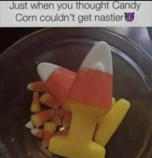 Food Memes, Funniest Memes, Gross Memes, Halloween Memes, Nasty Memes, Snack Memes, Weird Memes, WTF Memes, The meme shows a close-up of a bowl containing regular candy corn pieces alongside a much larger, glossy candy-corn-colored object. It has the familiar white, orange, and yellow layers, but its oversized, awkward shape makes it look less like a seasonal treat and more like a strange, vaguely suggestive candy creation.