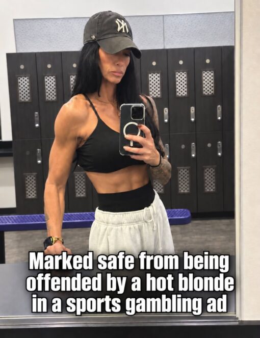Commercial Memes, Current Event Memes, Facebook Memes, Funniest Memes, Hot Girl Memes, Internet Memes, Offensive Memes, Pop Culture Memes, Social Media Memes, Sports Memes, Sydney Sweeney Nude ad, A muscular woman takes a mirror selfie in a gym locker room, wearing a black Yankees cap, black sports bra, and loose white sweatpants. Rows of lockers fill the background, giving the image a fitness-influencer, post-workout feel.