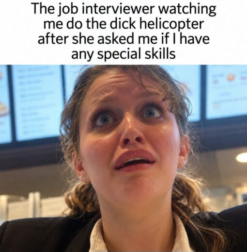 Awkward Memes, Career Memes, Cringe Memes, Dirty Mind Memes, Embarrassing Memes, Funniest Memes, HR Memes, Job Memes, NSFW, Penis Memes, Sex Memes, Work Memes, WTF Memes, The meme shows a close-up, low-angle photo of a young woman in business attire staring upward with wide, startled eyes and a slightly open mouth. Her expression reads as shocked, confused, and deeply uncomfortable, as if she is trying to process something wildly inappropriate happening in front of her. Above the image, the caption says: “The job interviewer watching me do the dick helicopter after she asked me if I have any special skills.” The professional-looking setting behind her makes the joke feel like it is happening in a workplace or interview environment, which heightens the awkwardness.