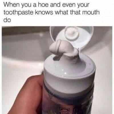 Blowjob Memes, Dirty Mind Memes, Double Meaning Memes, Funniest Memes, Hoe Memes, Innuendo Memes, Nasty Memes, NSFW, Oral Sex Memes, Sex Memes, Slut Meme, Teeth Memes, Whore Memes, The meme shows a close-up of a hand holding an open toothpaste container over a bathroom sink. A small blob of toothpaste has squeezed out onto the cap in a shape that looks suggestively phallic, with the lid flipped open behind it like a backdrop. At the top, the caption reads: “When you a hoe and even your toothpaste knows what that mouth do.” The ordinary bathroom setting makes the crude visual joke feel sudden and ridiculous.