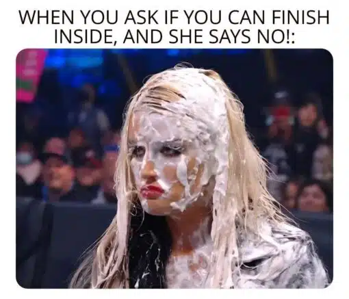 Climax Memes, Cum Memes, Dirty Talk Memes, Double Meaning Memes, Funniest Memes, Girlfriend Memes, Horny Memes, Innuendo Memes, Jizz Memes, NSFW, Relationship Memes, Sex Memes, Wrestling Memes, A woman with long blonde hair stands in what looks like a crowded arena or event setting, her face, hair, and upper body covered in thick white cream or foam. She has an exaggerated pouty, annoyed expression, staring off to the side as if disappointed or unimpressed by what just happened.
