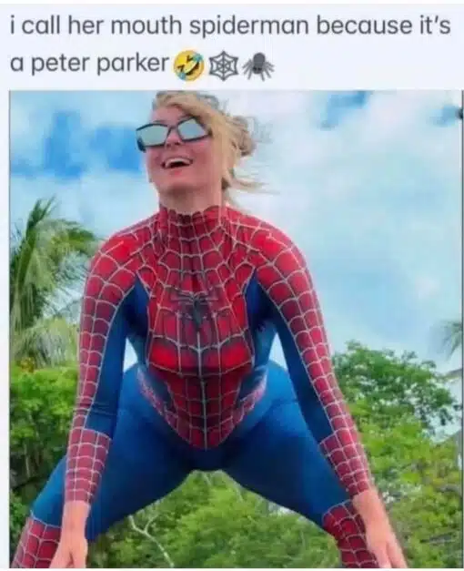 Blowjob Memes, Dirty Mind Memes, Double Meaning Memes, Funniest Memes, Innuendo Memes, Marvel Memes, NSFW, Oral Sex Memes, Play on Words Memes, Pun Memes, Sex Memes, Spider-Man Memes, Super Hero Memes, The meme shows a woman posing outdoors in a red-and-blue Spider-Man-style bodysuit, crouched in a superhero stance against a bright sky and green tropical-looking background. She is wearing dark sunglasses and smiling, which gives the image a playful cosplay-photo vibe.