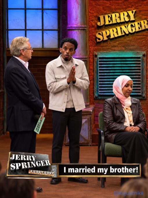 Brother Memes, Celebrity Memes, Funniest Memes, Ilhan Married Her Brother, Incest Memes, Marriage Memes, Offensive Memes, Political Memes, Pop Culture Memes, Sibling Memes, TV Series Memes, The image is staged like an episode of *The Jerry Springer Show*: a brick-wall studio set, bright talk-show lighting, and a large “JERRY SPRINGER” sign looming in the background. On the left, a host figure stands with a cue card while a man in the center gestures nervously with his hands clasped, as if making a shocking confession to the audience. On the right, a seated woman in a headscarf looks away with a restrained, uncomfortable expression. The lower-third graphic mimics a sensational TV chyron, with the show branding, the hashtag “#JERRYJERRY,” and the punchline: “I married my brother!”