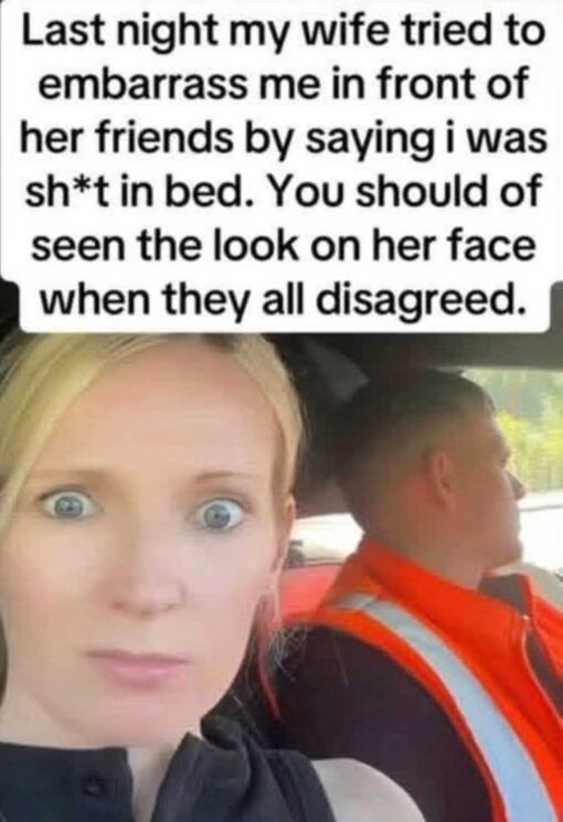 Cheating Memes, Couple Memes, Dirty Mind Memes, Embarrassing Memes, Funniest Memes, Marriage Memes, NSFW, Offensive Memes, Relationship Memes, Revenge Memes, Savage Memes, Sex Memes, Wife Memes, The meme shows a selfie-style photo taken inside a car. In the foreground, a blonde woman stares directly into the camera with wide, stunned eyes and a blank, frozen expression, while a man in an orange high-visibility vest sits beside her in the driver’s seat, facing away and looking out the window.