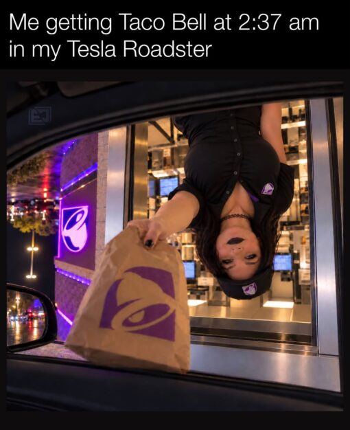 Car Memes, Driving Memes, Fast Food Memes, Food Memes, Funniest Memes, Futuristic Memes, Hungry Memes, Nightclub Memes, Poor Decisions Memes, Taco Bell Memes, Tesla Roadster, Weird Memes, WTF Memes, A nighttime drive-thru scene is framed from inside a car, with Taco Bell’s purple glow lighting up the window and street outside. A Taco Bell employee leans dramatically upside down out of the service window, handing a brown Taco Bell bag toward the driver like gravity no longer applies. The caption reads, “Me getting Taco Bell at 2:37 am in my Tesla Roadster,” turning an already surreal late-night fast-food pickup into something even more absurdly futuristic and cinematic.