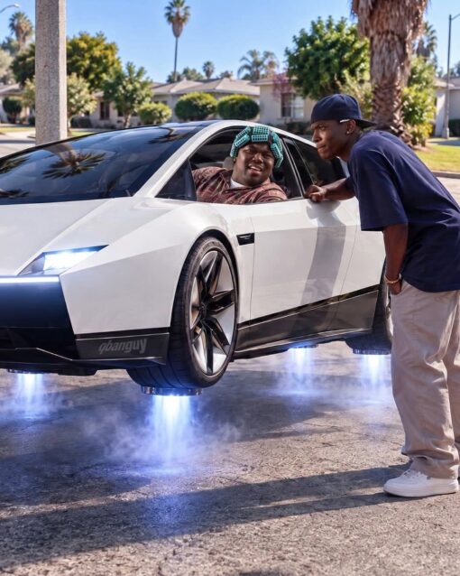 90s Memes, Car Memes, CGI Memes, Friday Memes, Funniest Memes, Futuristic Memes, Mashup Memes, Movie Memes, Pop Culture Memes, Tech Memes, Tesla Roadster, Weird Memes, A glossy, cinematic street scene shows a boxy white futuristic sports car hovering inches above a suburban road, blue-white thrusters blasting downward through misty exhaust. Inside the driver’s window, a man styled like Big Worm from Friday leans out in curlers and a patterned shirt, while a younger man in a sideways cap and baggy clothes leans in suspiciously from the sidewalk.