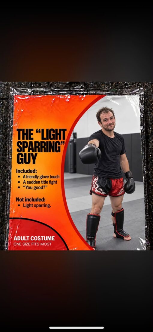 Archetypes, Boxing Memes, Costume Memes, Fight Memes, Fitness Memes, Funniest Memes, Gym Memes, Martial Arts Memes, MMA Memes, Sports Memes, Workout Memes, The meme is designed like a Halloween costume package, with a bright orange-and-red label on the left and a photo of a man in boxing gloves, shin guards, and fight shorts on the right. He stands in a gym with one glove extended for a friendly touch, wearing a sheepish, slightly smug expression that suggests he knows exactly what he is about to do. The fake costume promises “THE ‘LIGHT SPARRING’ GUY,” listing accessories like a friendly glove touch, a sudden title fight, and the classic after-the-fact check-in, “You good?” The punchline is in the “Not included” section: actual light sparring is nowhere to be found.