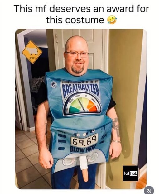 Alcohol Memes, Blowjob Memes, Costume Memes, Dirty Mind Memes, Double Meaning Memes, Drinking Memes, Drunk Memes, DWI Memes, Funniest Memes, Innuendo Memes, NSFW, Penis Memes, Sex Memes, A man stands in a hallway wearing a bulky, homemade-looking costume shaped like a “FIELD MOBILE BREATHALYZER.” The outfit has a large fake gauge across the chest, a digital-style readout on the front showing “69.69,” and a label that says “BLOW HERE.” The punchline is visual: a protruding tube sticks out from the lower front of the costume right under the “BLOW HERE” instruction, turning what should be a police-style breath test gag into a very obvious adult innuendo. The top caption praises the costume as award-worthy, with a laughing emoji reinforcing that the joke is in how shamelessly ridiculous it is.
