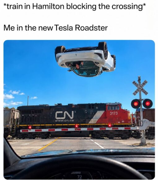 Car Memes, Corporation Memes, Current Event Memes, Driving Memes, Funniest Memes, Futuristic Memes, Road Memes, Road Sign Memes, Tech Memes, Tesla Roadster, Traffic Memes, The meme shows a driver’s-eye view from inside a car stopped at a railroad crossing, where a red-and-black CN locomotive is blocking the road behind lowered crossing arms and flashing red lights. Over the scene, a white Tesla Roadster has been edited into the sky upside down, as if it has launched over the train instead of waiting in traffic. The top caption reads “*train in Hamilton blocking the crossing*” followed by “Me in the new Tesla Roadster.” The train carries the markings “3173,” “CN,” and “www.cn.ca,” while the crossing sign text is transcribed as “RAIL SING” and “CROSS ROAD,” adding to the slightly chaotic, absurd look of the scene.