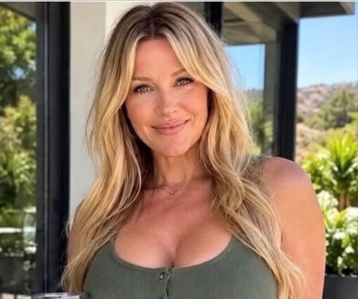Corporation Memes, Funniest Memes, Hot Girl Memes, People Memes, Shopping Memes, Walmart Memes, Women Memes, A close-up photo shows a smiling blonde woman posing outdoors in bright daylight, with long wavy hair, a green tank top, and a polished, influencer-style look. Behind her are large windows, greenery, and a sunny suburban-looking backdrop, giving the image a casual but carefully staged lifestyle-photo feel. The only transcribed meme text is “Walmart,” a blunt one-word label that appears to frame the entire image through the lens of the big-box retail chain.